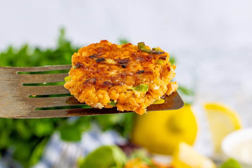 salmon cakes on a metal fish spatula