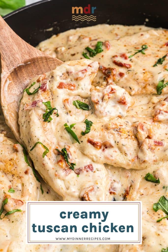 creamy tuscan chicken on a wooden spoon with text overlay for pinterest