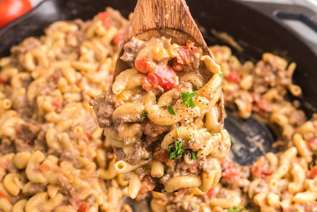 close up of wooden spoon full of cheeseburger macaroni skillet