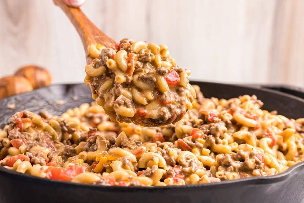 straight on shot of spoon full of cheeseburger macaroni skillet