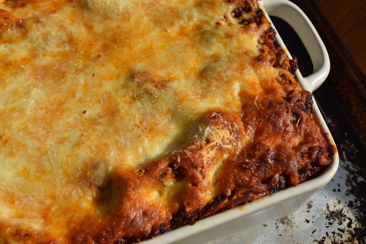 Whole 7 layer lasagna on baking sheet fresh from the oven