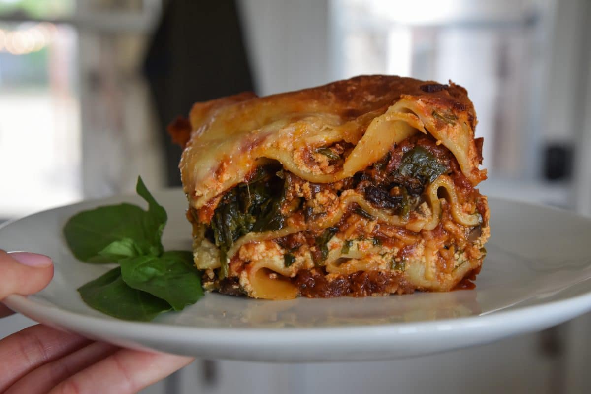 Slice of 7 layer lasagna on a plate