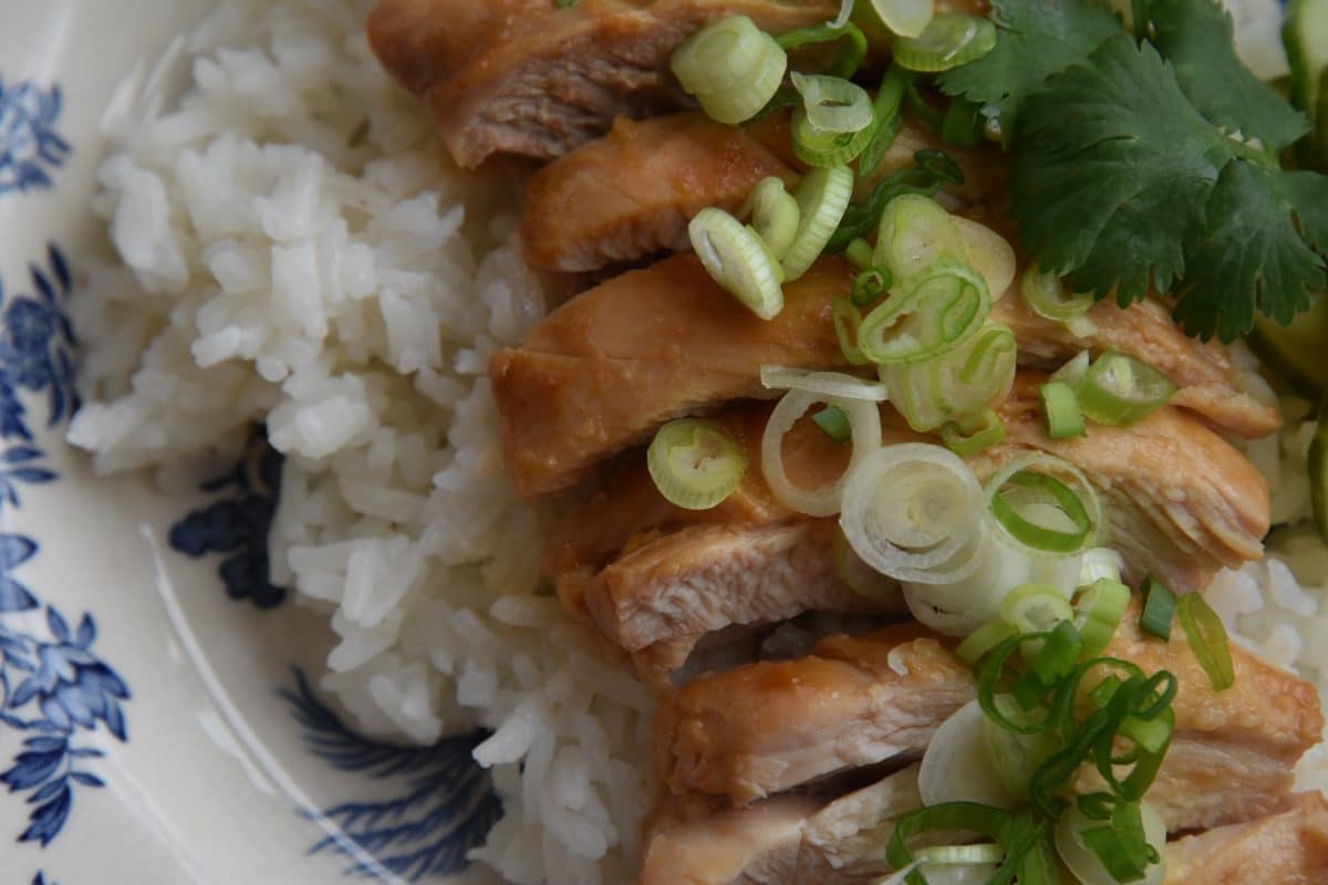 close up of miso chicken on a bed of rice topped with scallions